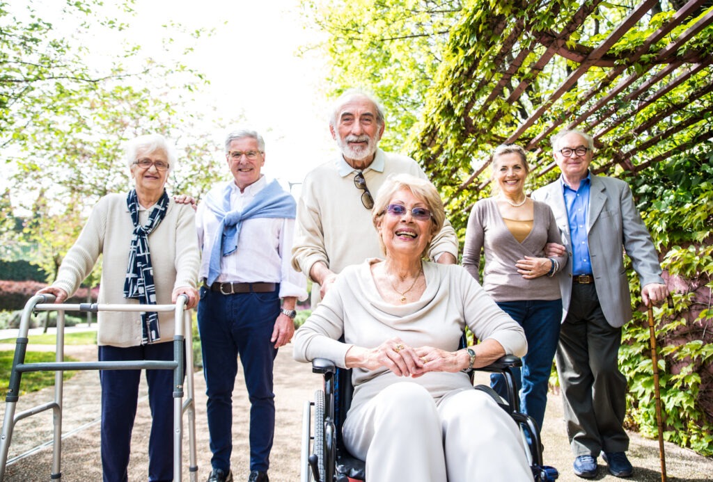 Group Of Senior People With Some Diseases Walking Outdoors - Mature Group Of Friends Spending Time Together